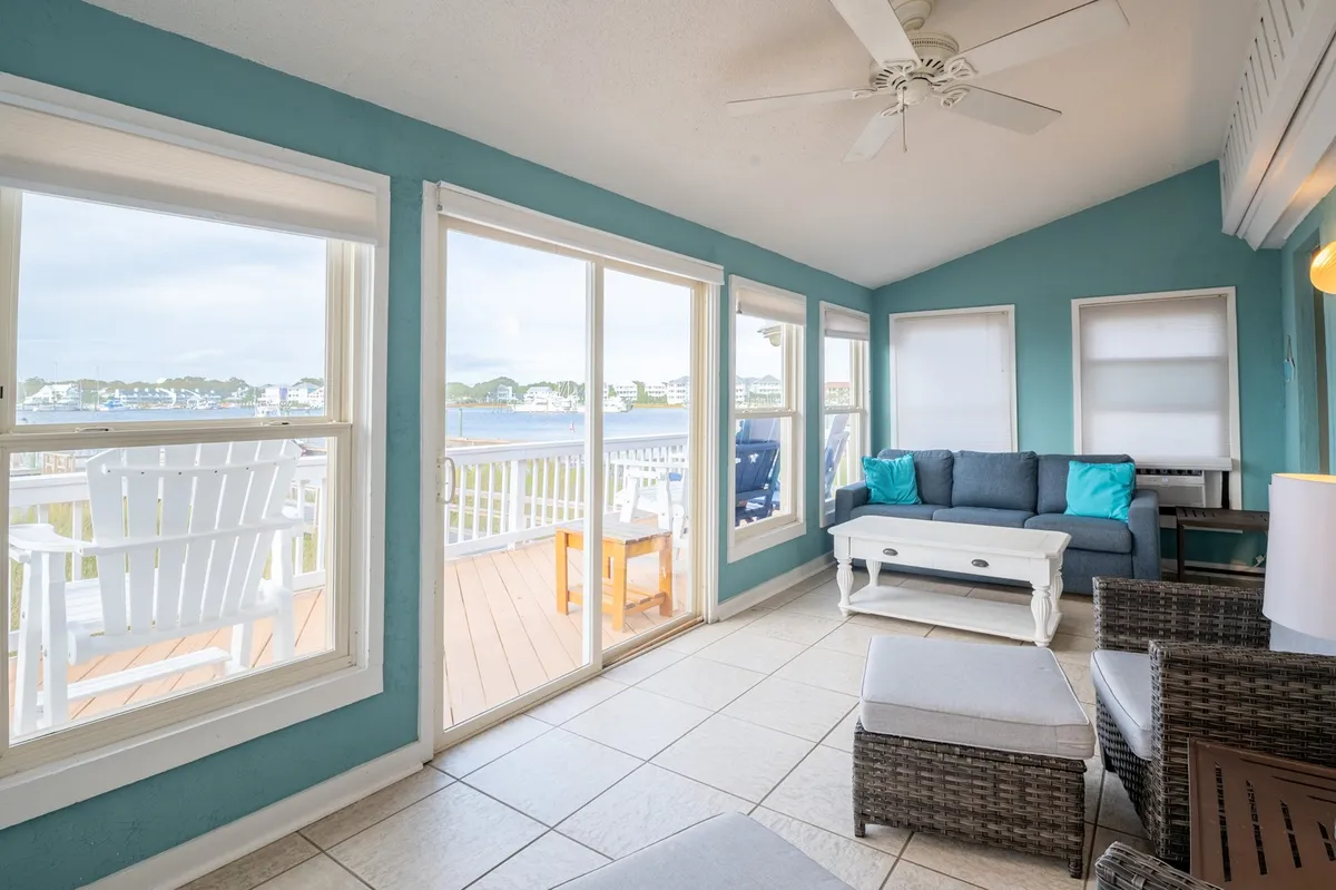 A tranquil seating area near large windows, with comfortable blue-accented furniture and a clear view outdoors. The space feels open and inviting, ideal for unwinding with your dog after exploring nearby attractions.